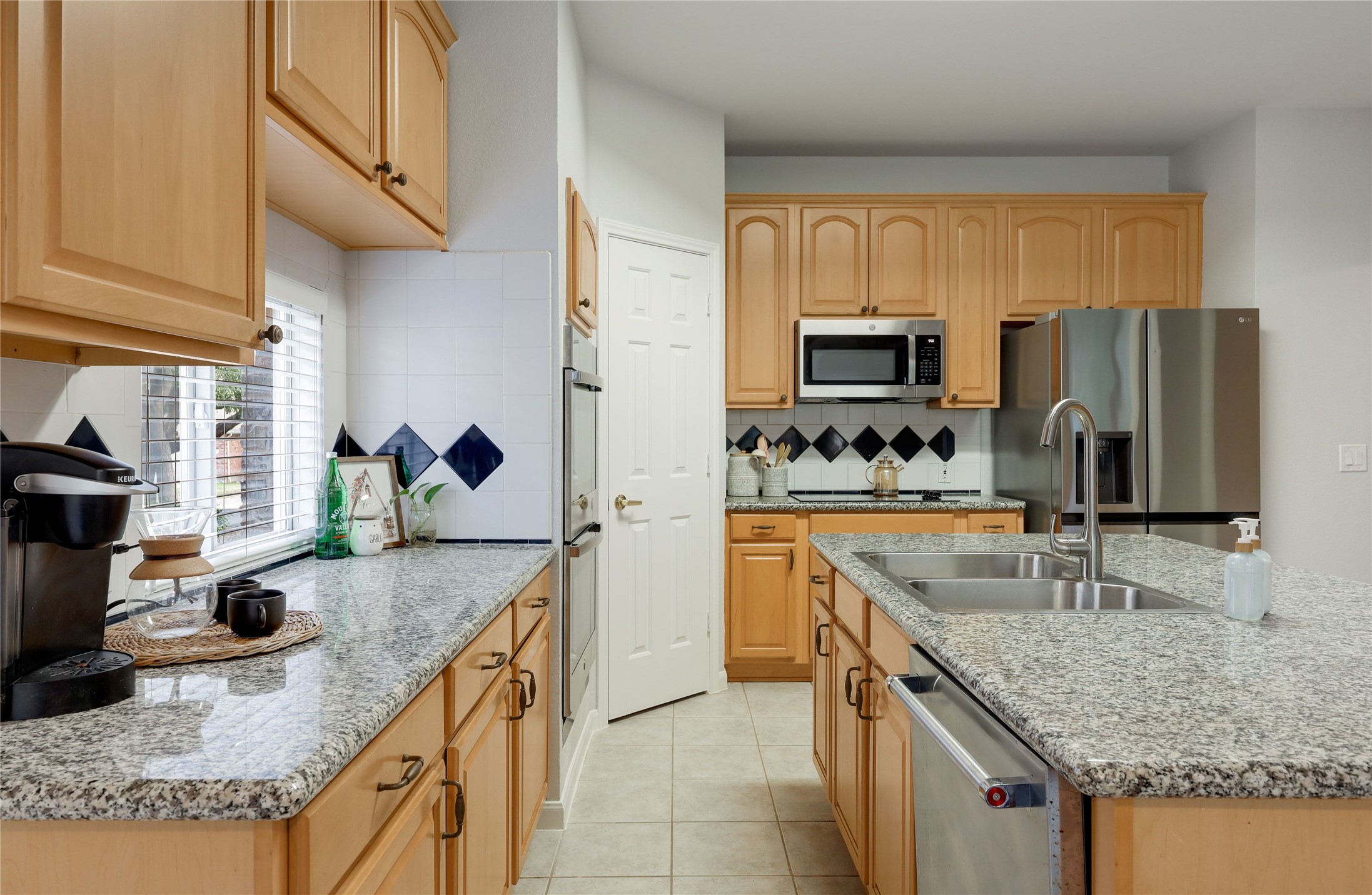 225 Trophy Pass Austin, TX 78748 - Photo 14 of 30 Natural wood cabinetry and granite counters give the kitchen a warm, timeless feel.