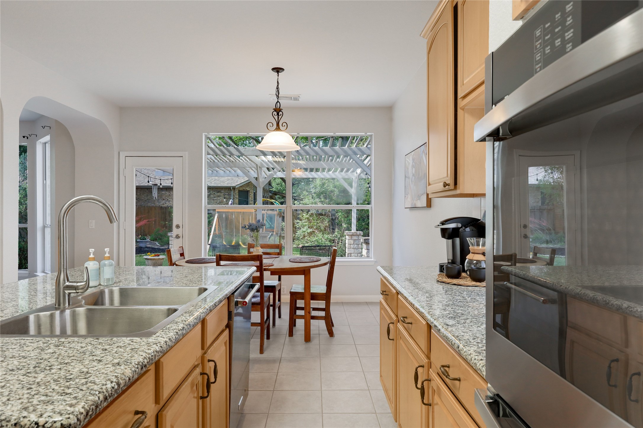 225 Trophy Pass Austin, TX 78748 - Photo 15 of 30 This kitchen keeps everything within reach with generous counter space, great storage, and an easy connection to the breakfast area and backyard.