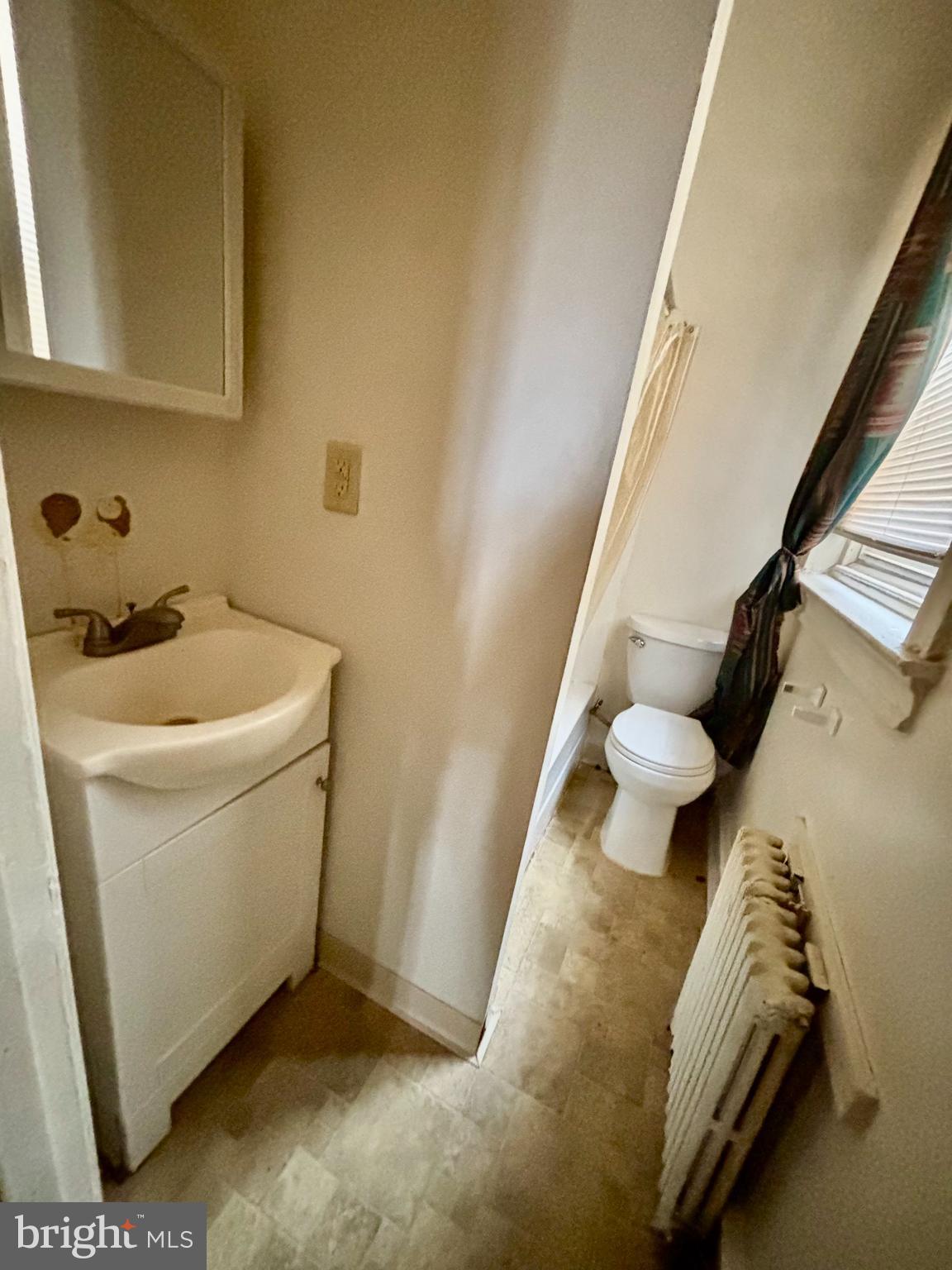 134 North Ruby Street Philadelphia, PA 19139 - Photo 17 of 34 a bathroom with a sink and mirror with bathtub