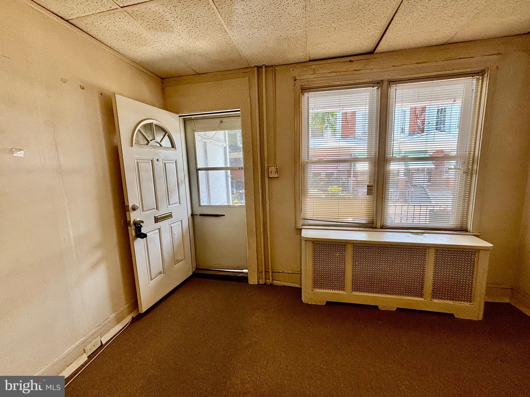134 North Ruby Street Philadelphia, PA 19139 - Photo 4 of 34 a view of an empty room with a fireplace and a window