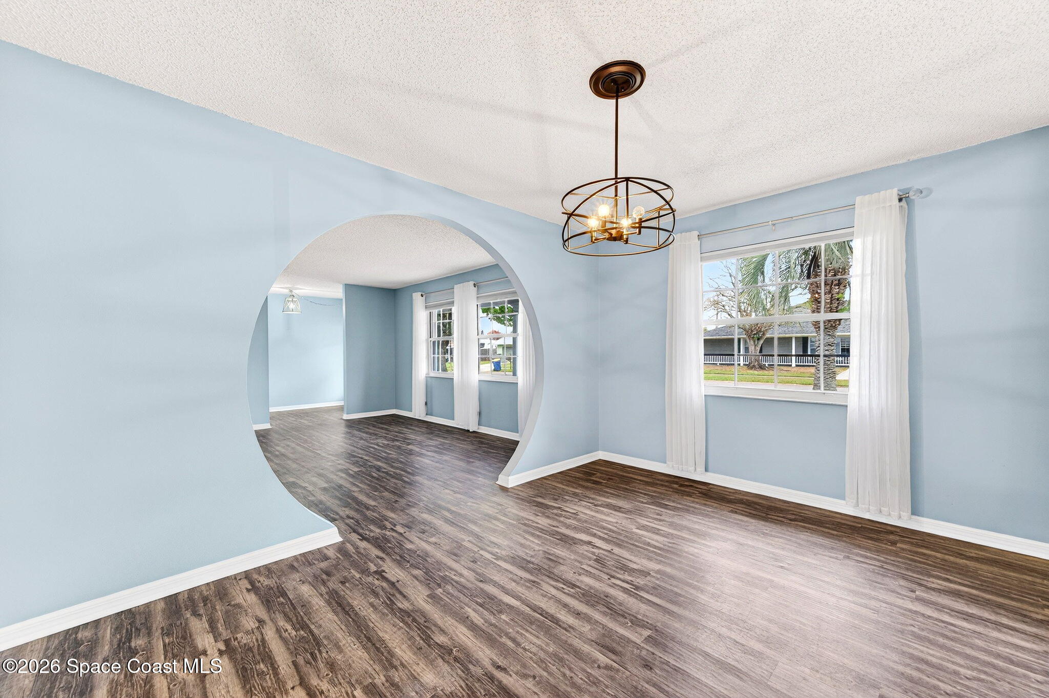 990 Boxford Lane Rockledge, FL 32955 - Photo 11 of 41 a view of an empty room with window and wooden floor