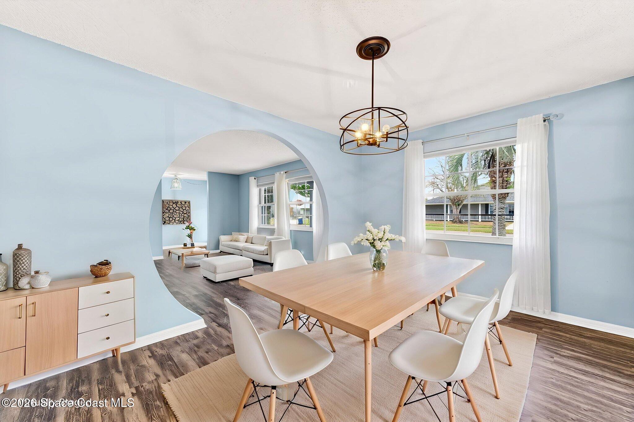 990 Boxford Lane Rockledge, FL 32955 - Photo 12 of 41 a view of a dining room with furniture wooden floor and chandelier
