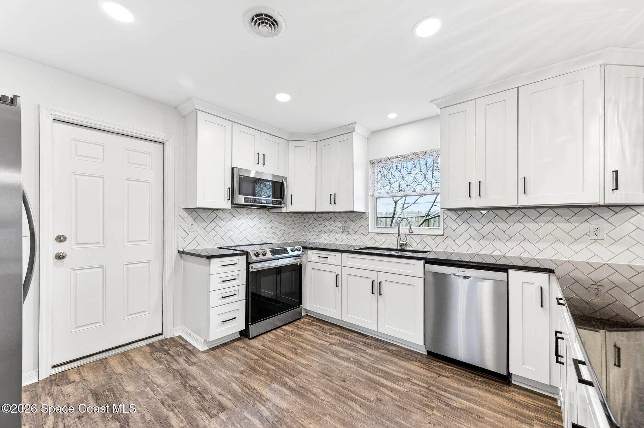 990 Boxford Lane Rockledge, FL 32955 - Photo 16 of 41 a kitchen with stainless steel appliances granite countertop a stove and a sink
