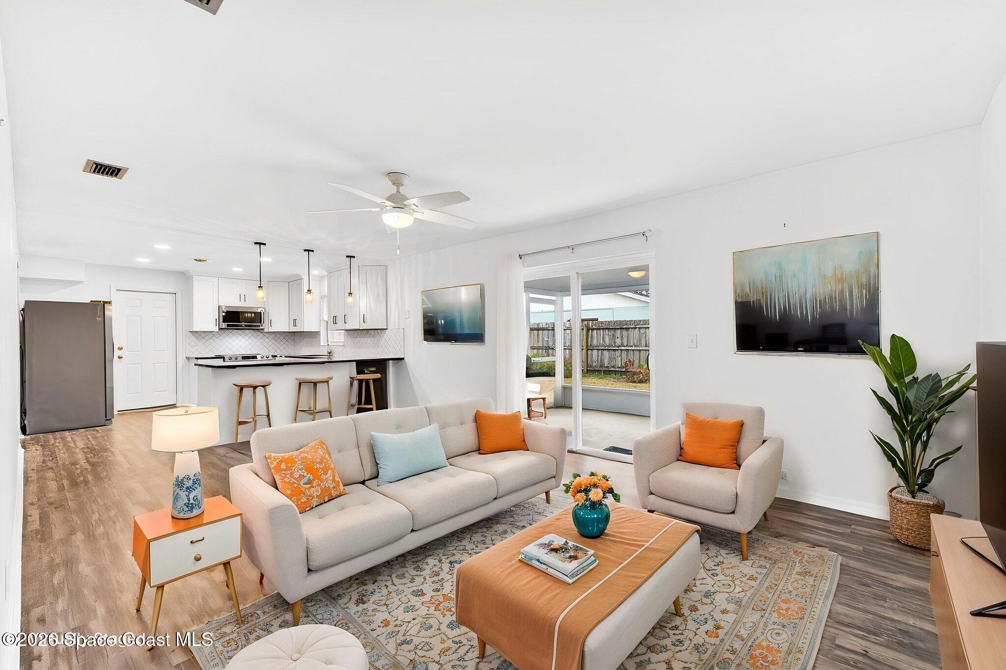 990 Boxford Lane Rockledge, FL 32955 - Photo 22 of 41 a living room with furniture kitchen view and a flat screen tv