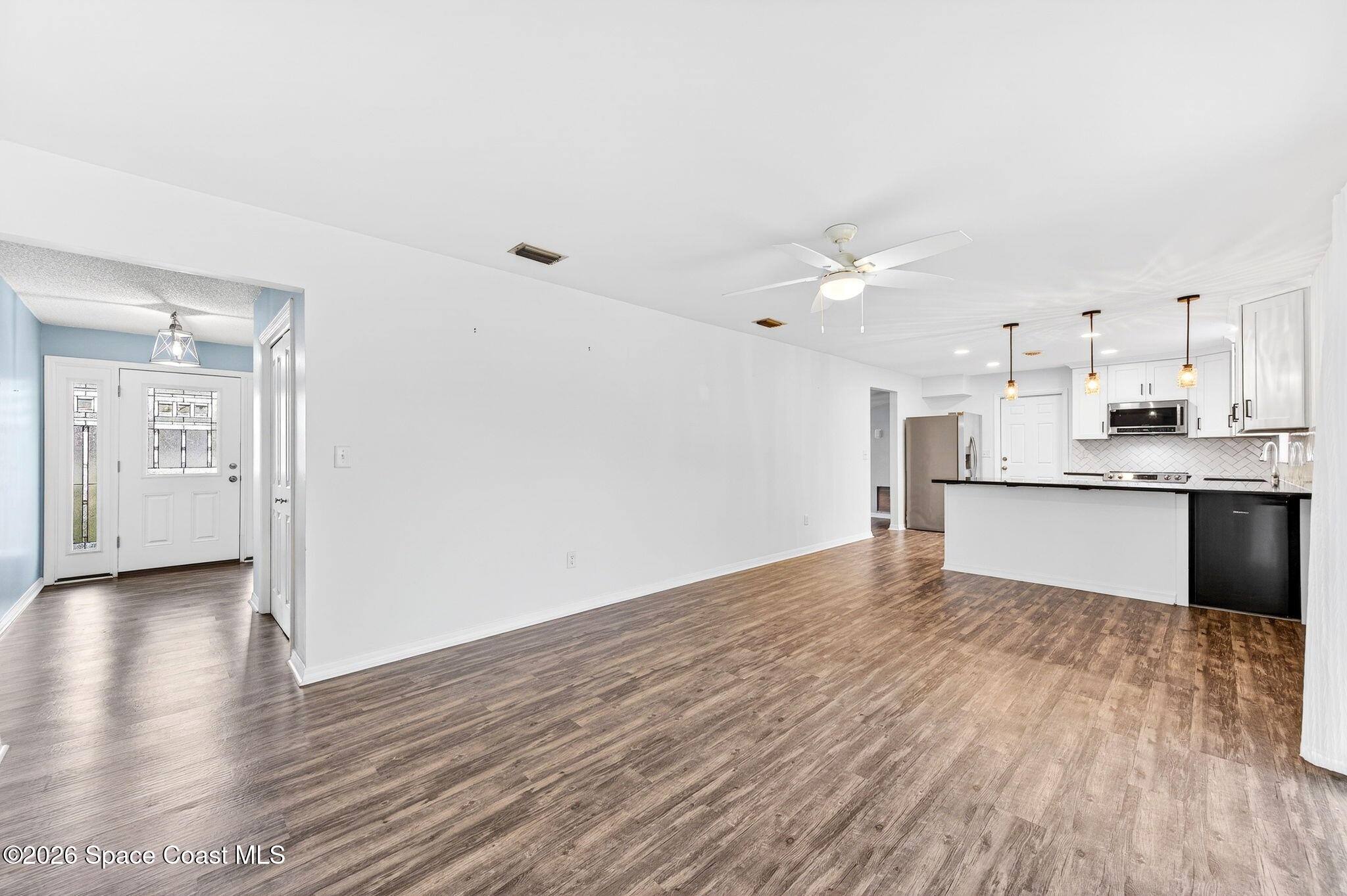 990 Boxford Lane Rockledge, FL 32955 - Photo 23 of 41 a view of kitchen with wooden floor and window