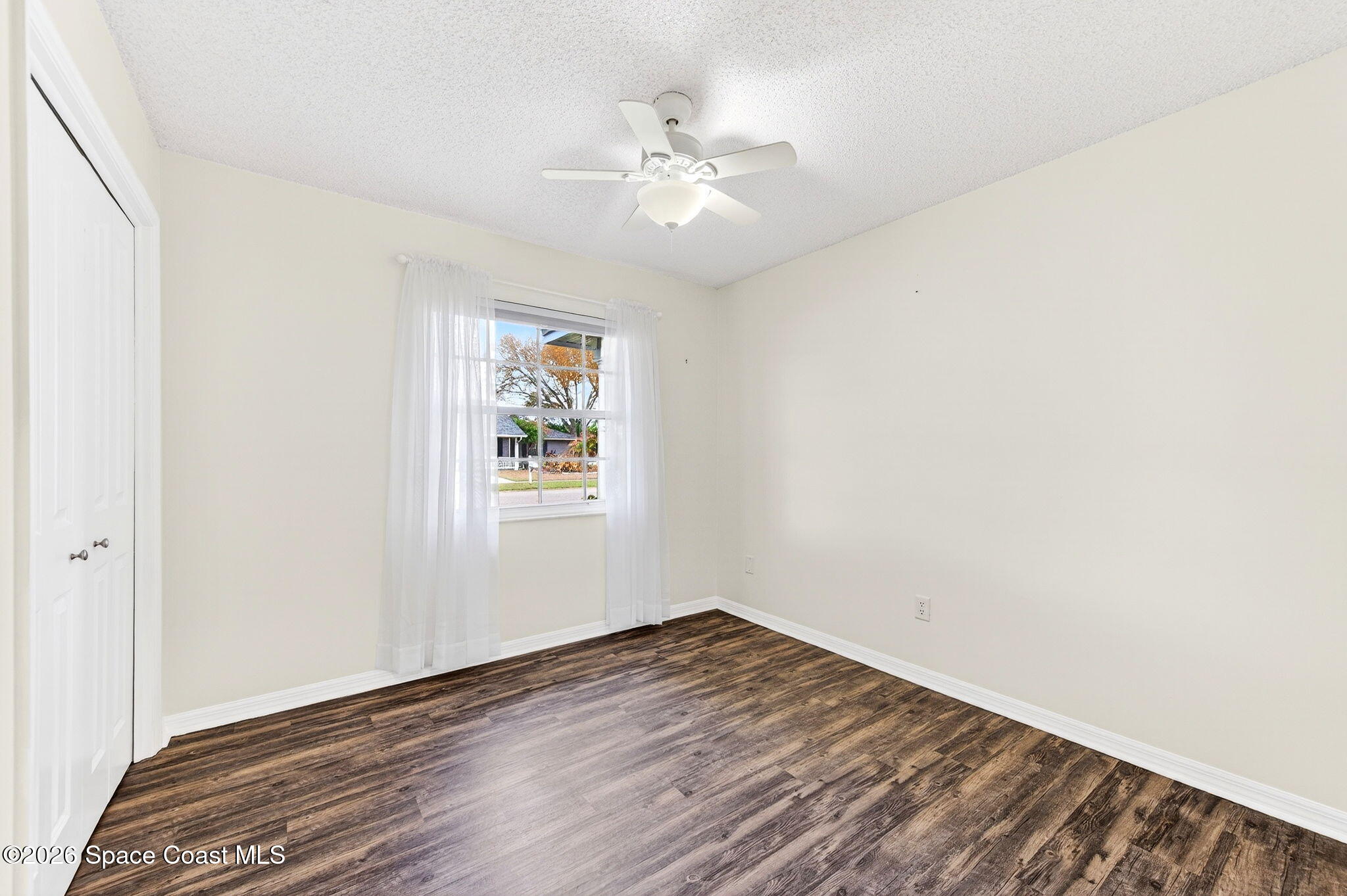 990 Boxford Lane Rockledge, FL 32955 - Photo 25 of 41 an empty room with wooden floor and windows