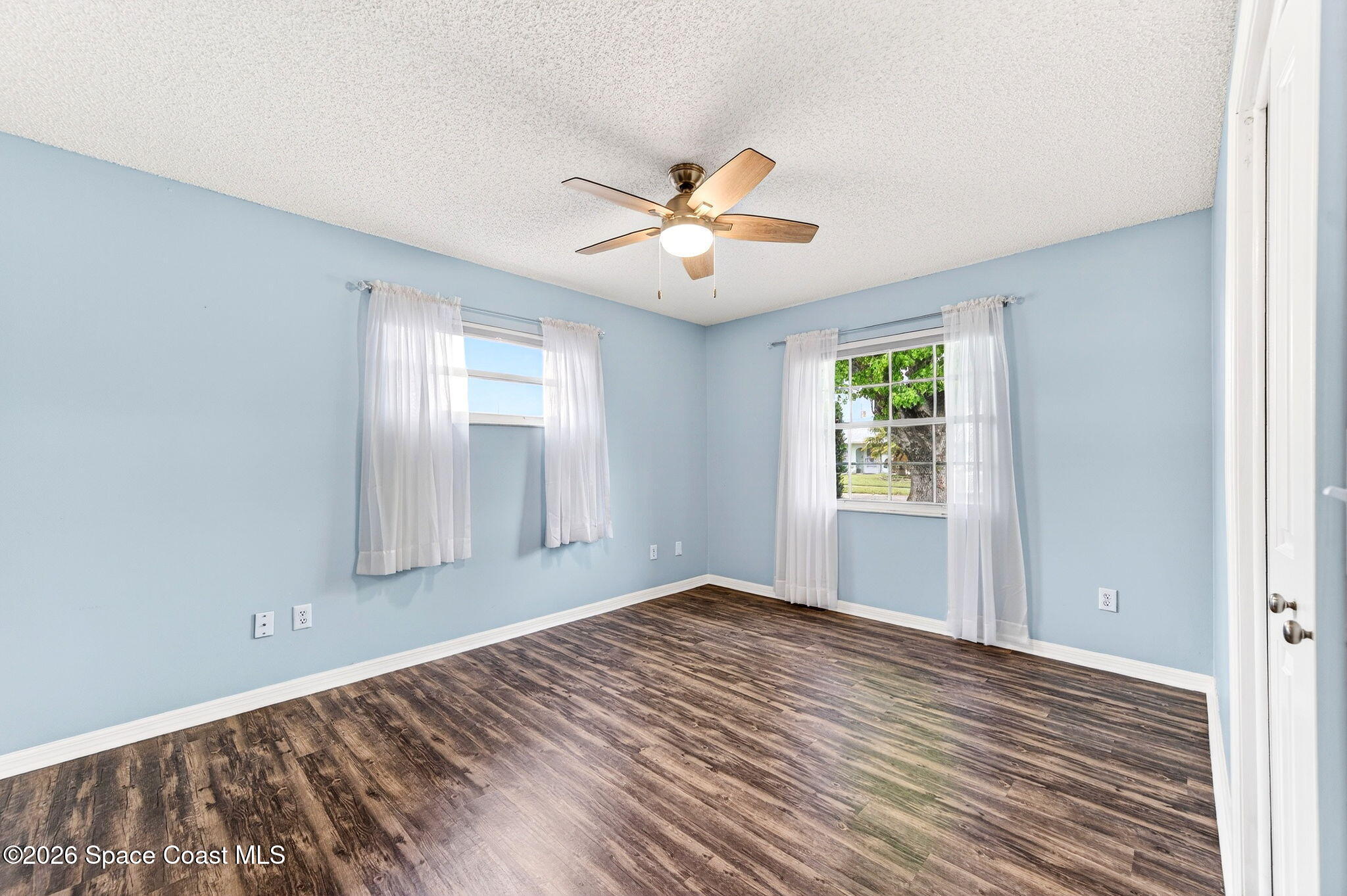 990 Boxford Lane Rockledge, FL 32955 - Photo 26 of 41 a view of empty room with wooden floor and fan