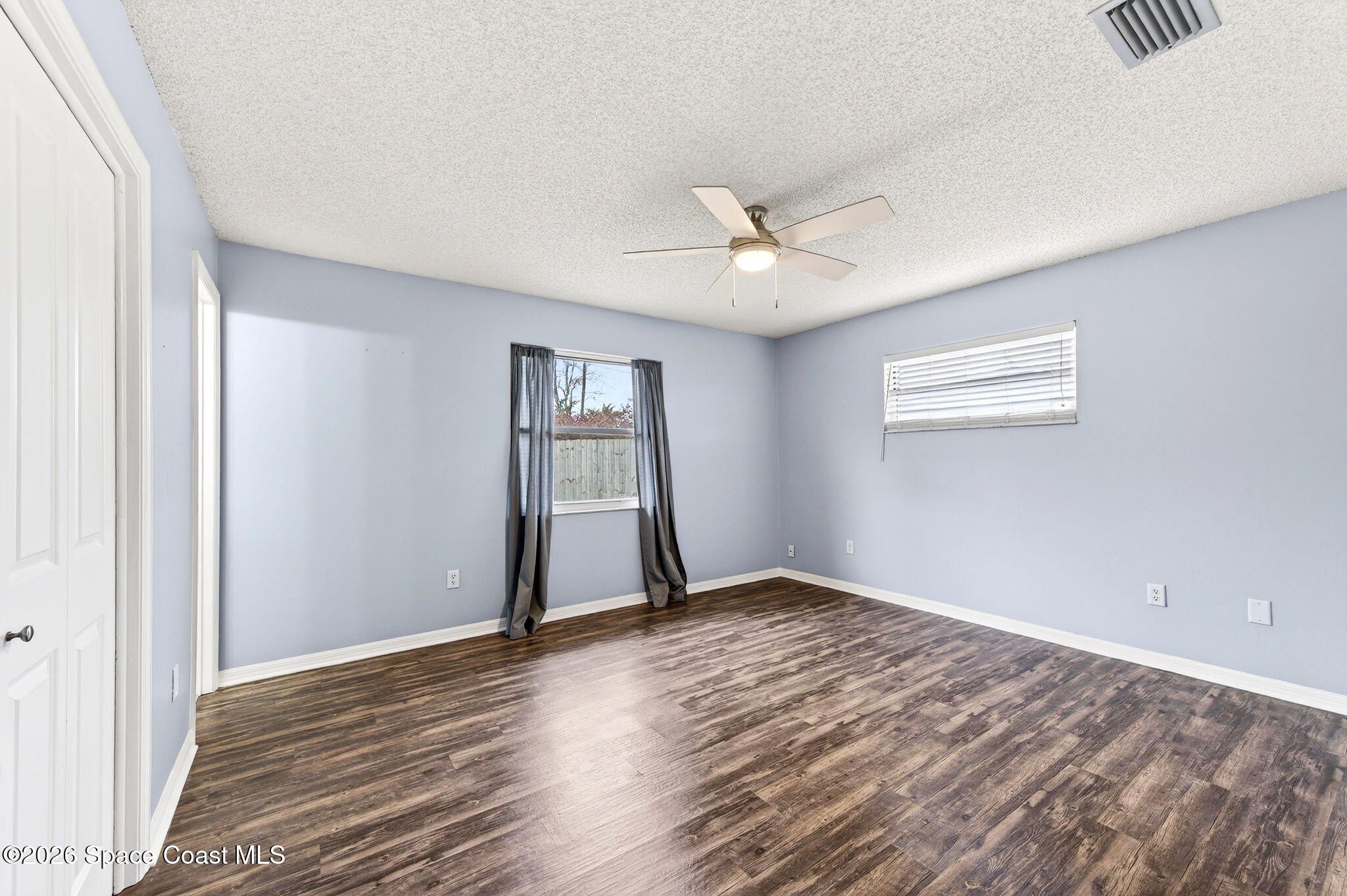 990 Boxford Lane Rockledge, FL 32955 - Photo 29 of 41 a view of an empty room with window and wooden floor