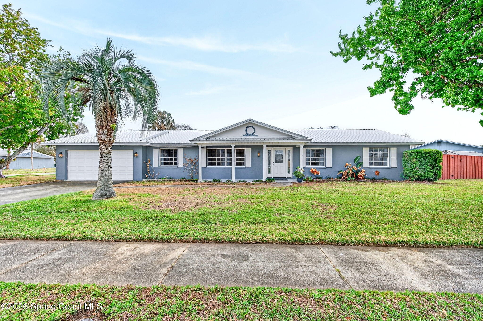 990 Boxford Lane Rockledge, FL 32955 - Photo 3 of 41 a front view of a house with a garden