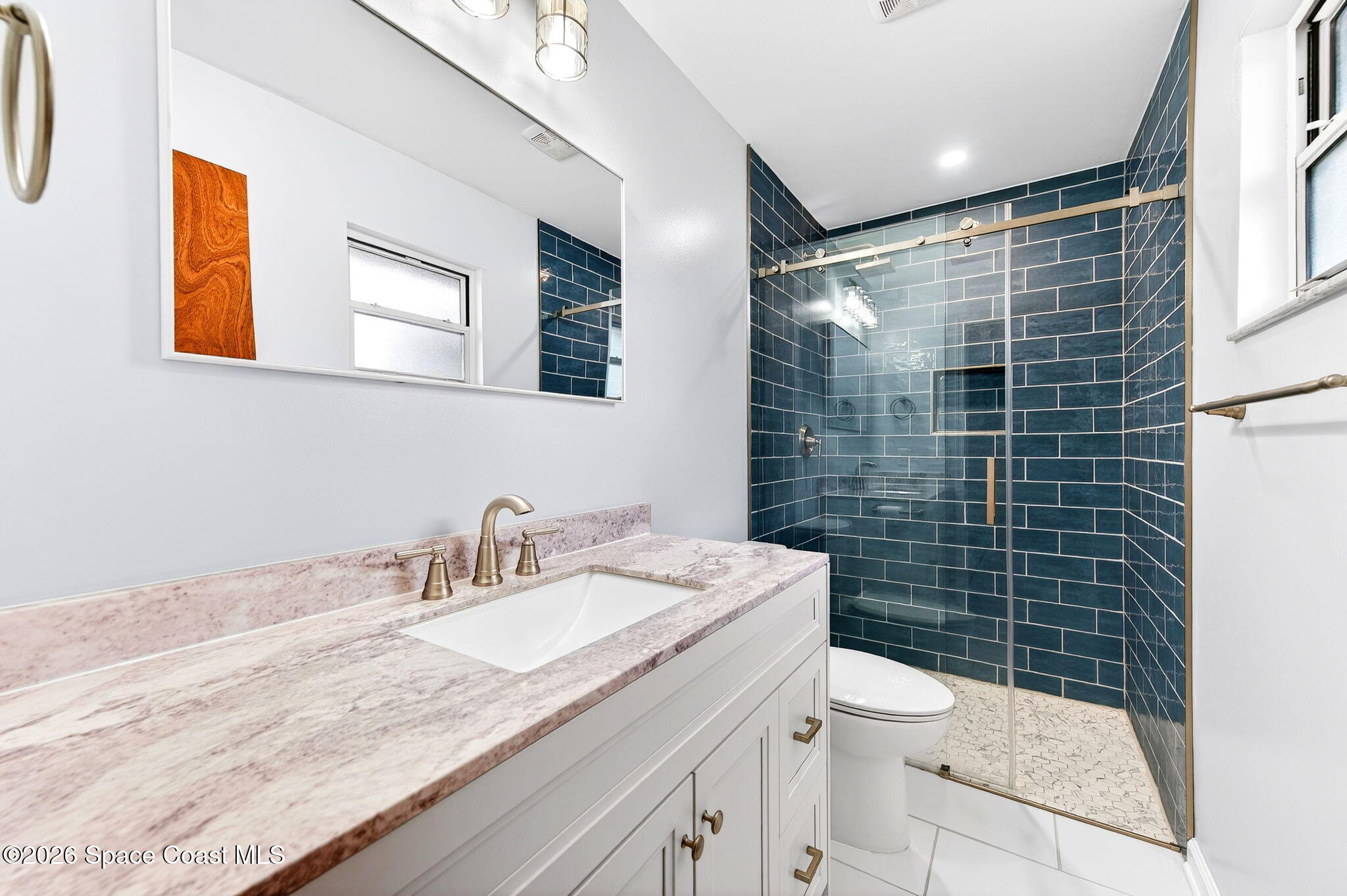 990 Boxford Lane Rockledge, FL 32955 - Photo 31 of 41 a bathroom with a granite countertop sink toilet and shower