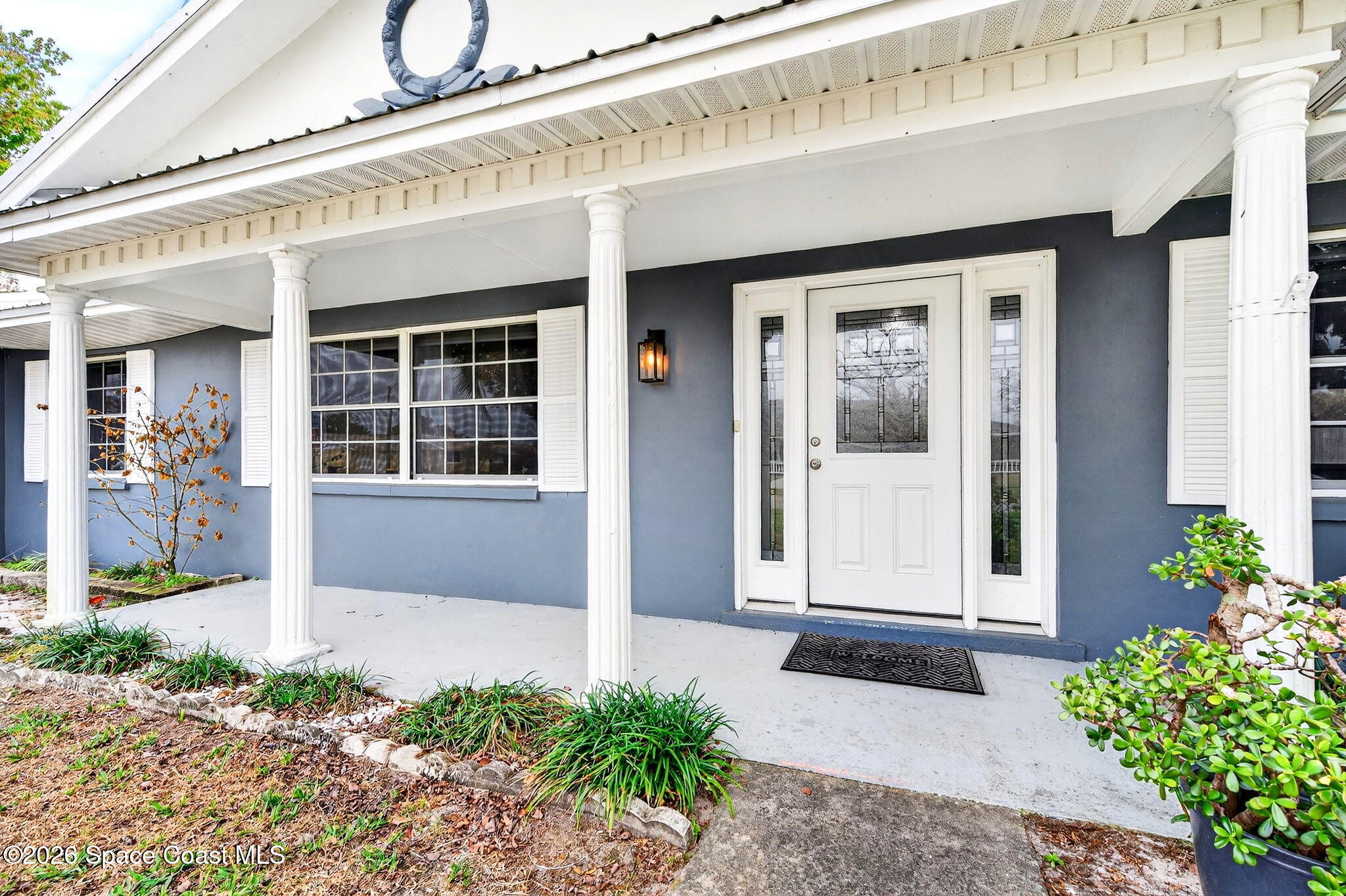 990 Boxford Lane Rockledge, FL 32955 - Photo 4 of 41 a front view of a house with a porch