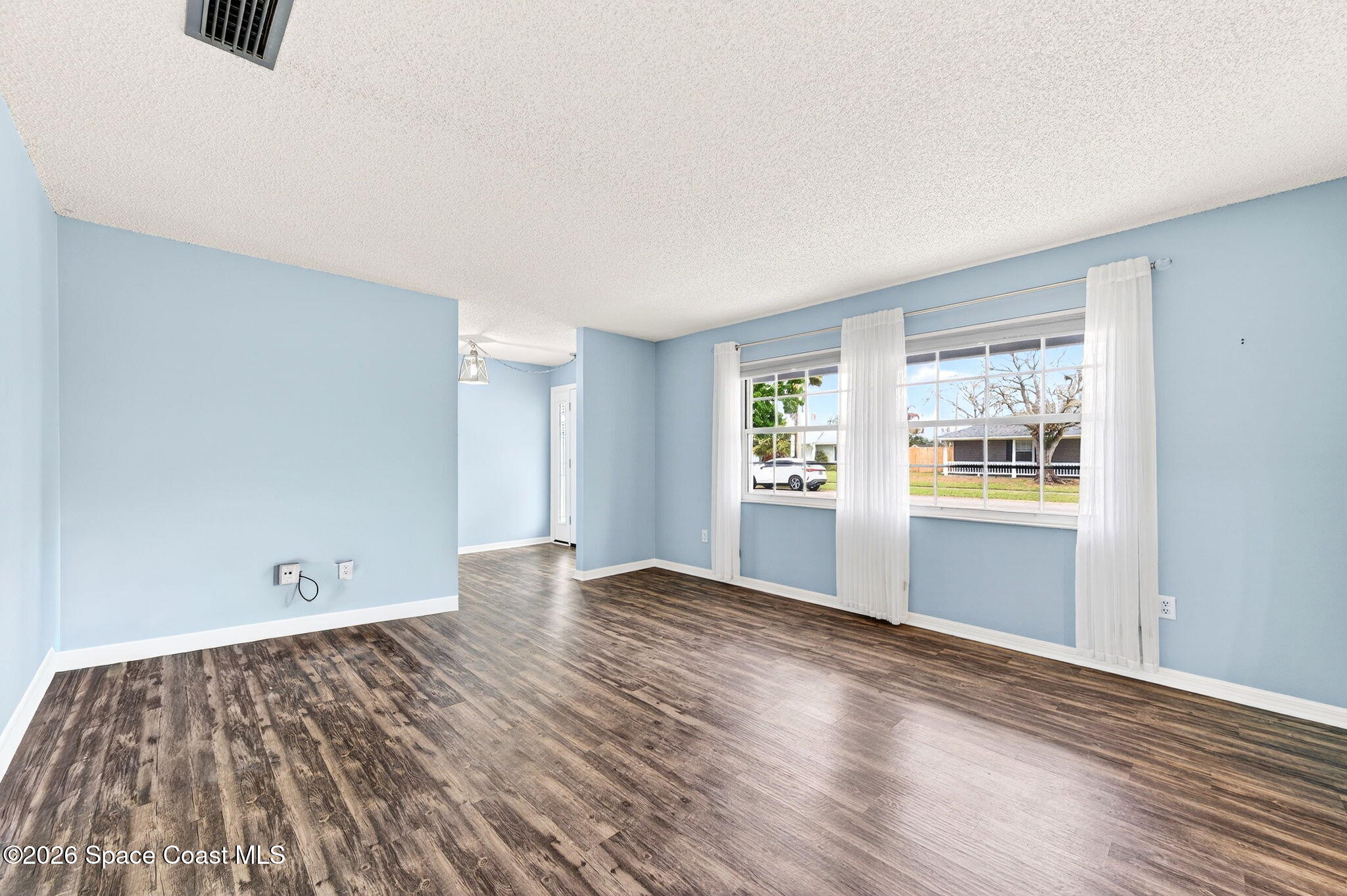 990 Boxford Lane Rockledge, FL 32955 - Photo 7 of 41 wooden floor in an empty room with a window
