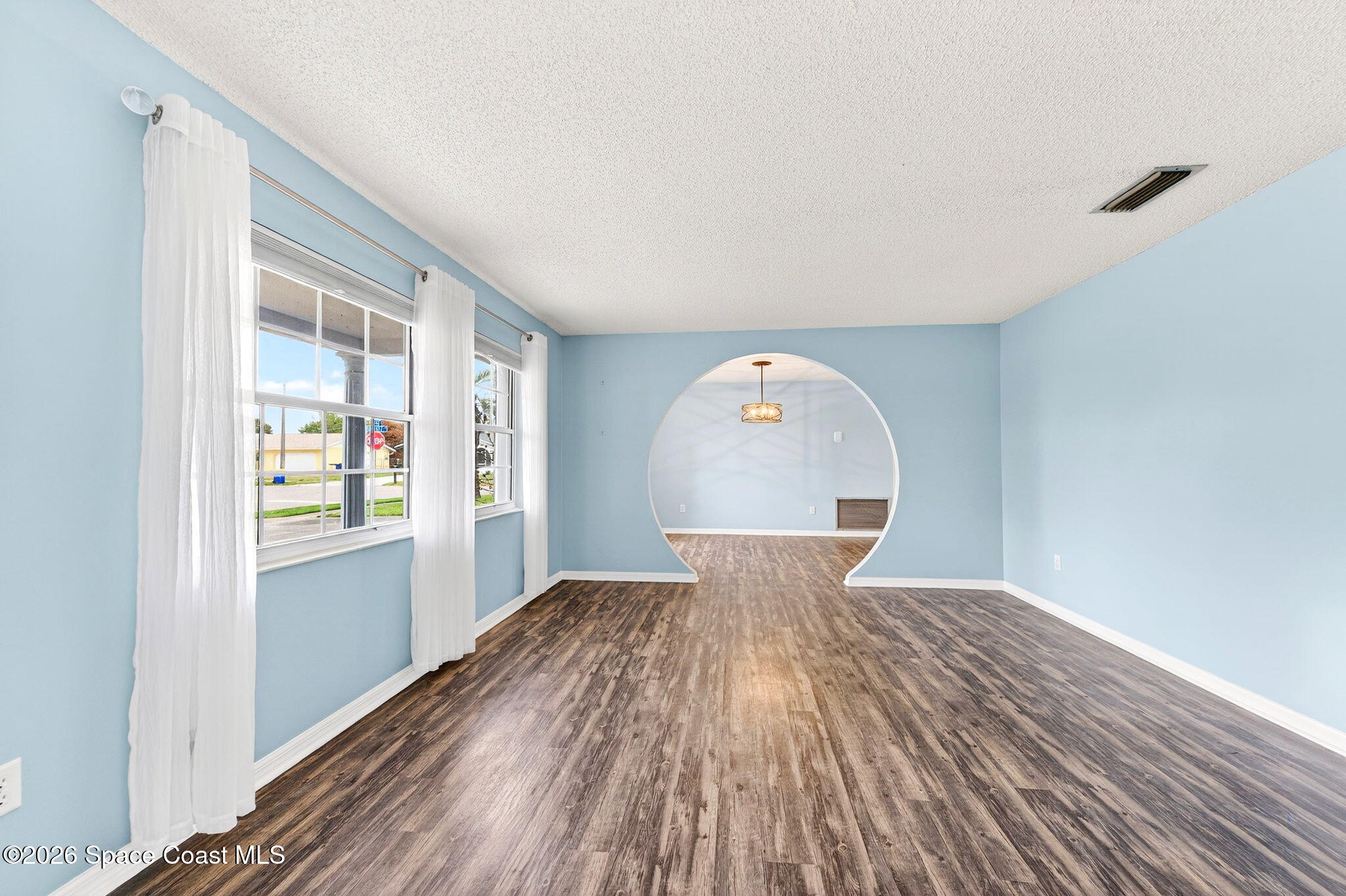 990 Boxford Lane Rockledge, FL 32955 - Photo 8 of 41 a view of a livingroom with wooden floor and a window
