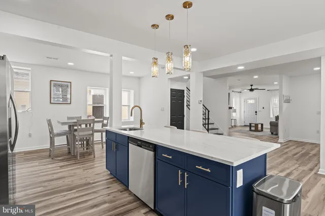 a large kitchen with a table and chairs