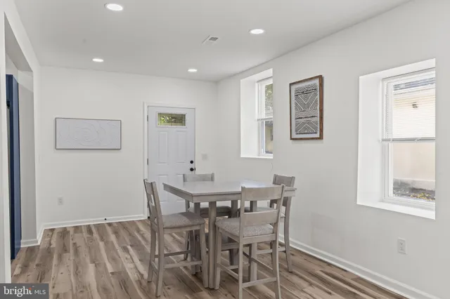 a view of a dining room with furniture and a window