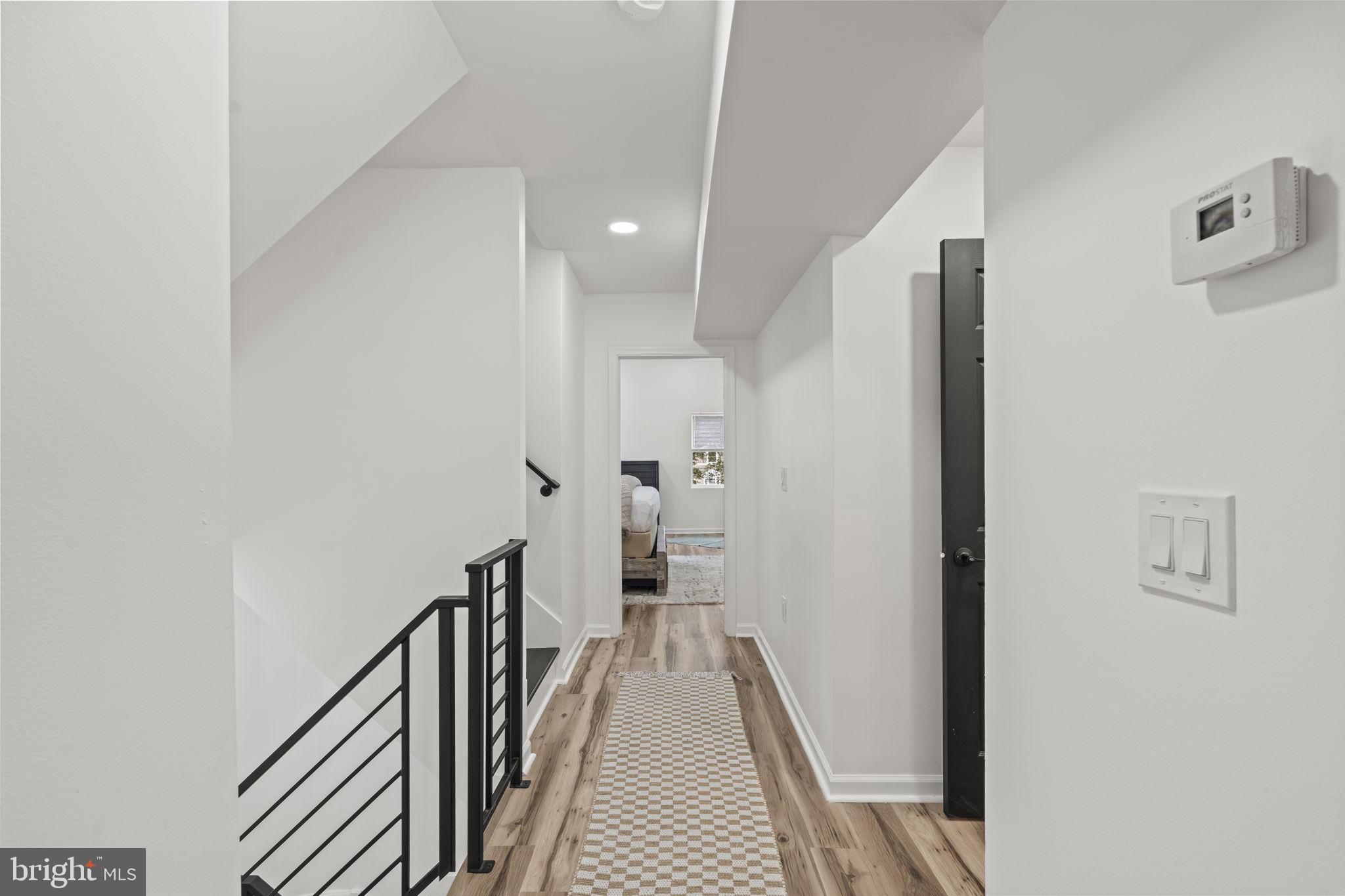 5320 Wynnefield Avenue Philadelphia, PA 19131 - Photo 14 of 33 a view of a hallway with wooden floor and staircase