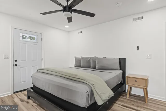 a bedroom with a bed and a ceiling fan
