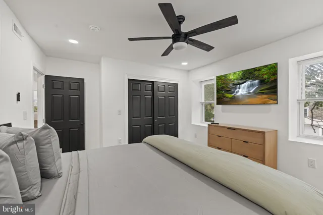 a bedroom with a bed and a flat screen tv