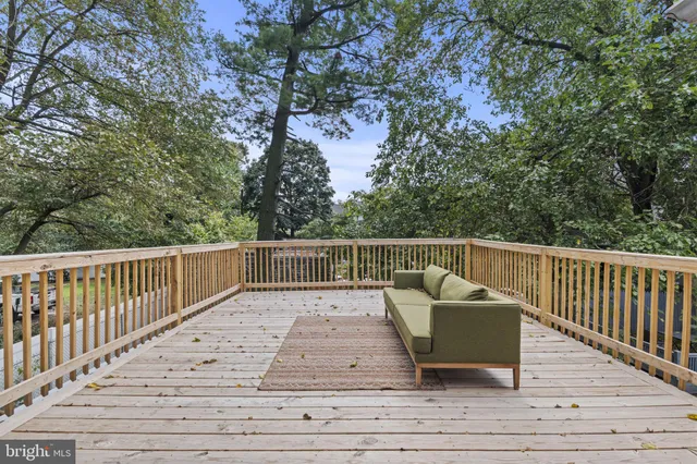 a balcony with wooden floor and fence