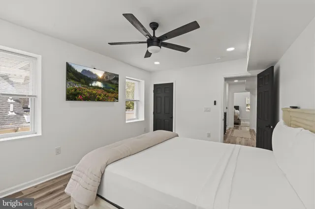 a bedroom with a large bed and a ceiling fan