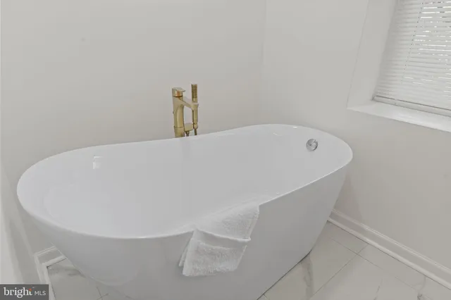 a white bath tub sitting in a bathroom