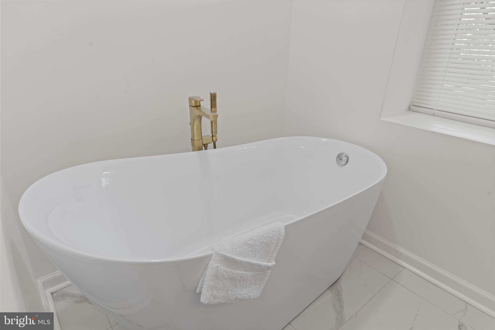5320 Wynnefield Avenue Philadelphia, PA 19131 - Photo 24 of 33 a white bath tub sitting in a bathroom