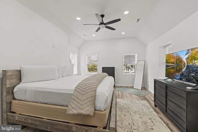 a room with a bed and a dresser in it