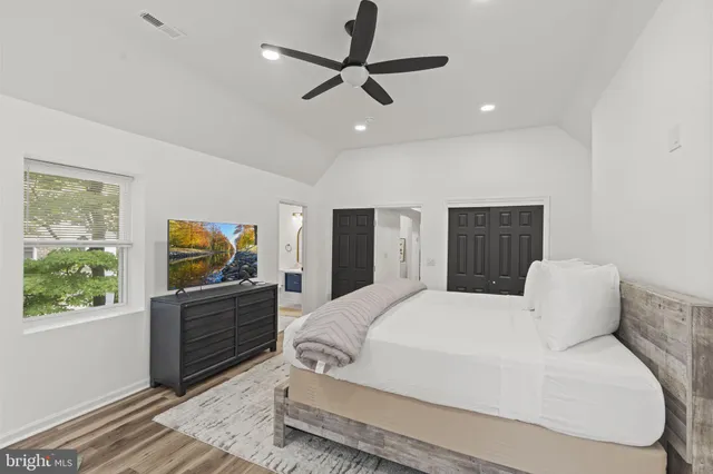 a bedroom with a bed and a flat screen tv