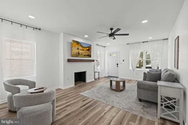a living room with furniture and a fireplace