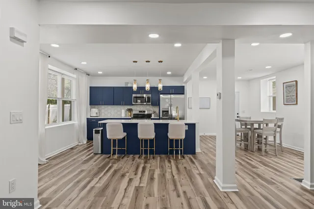 a large kitchen with a table and chairs