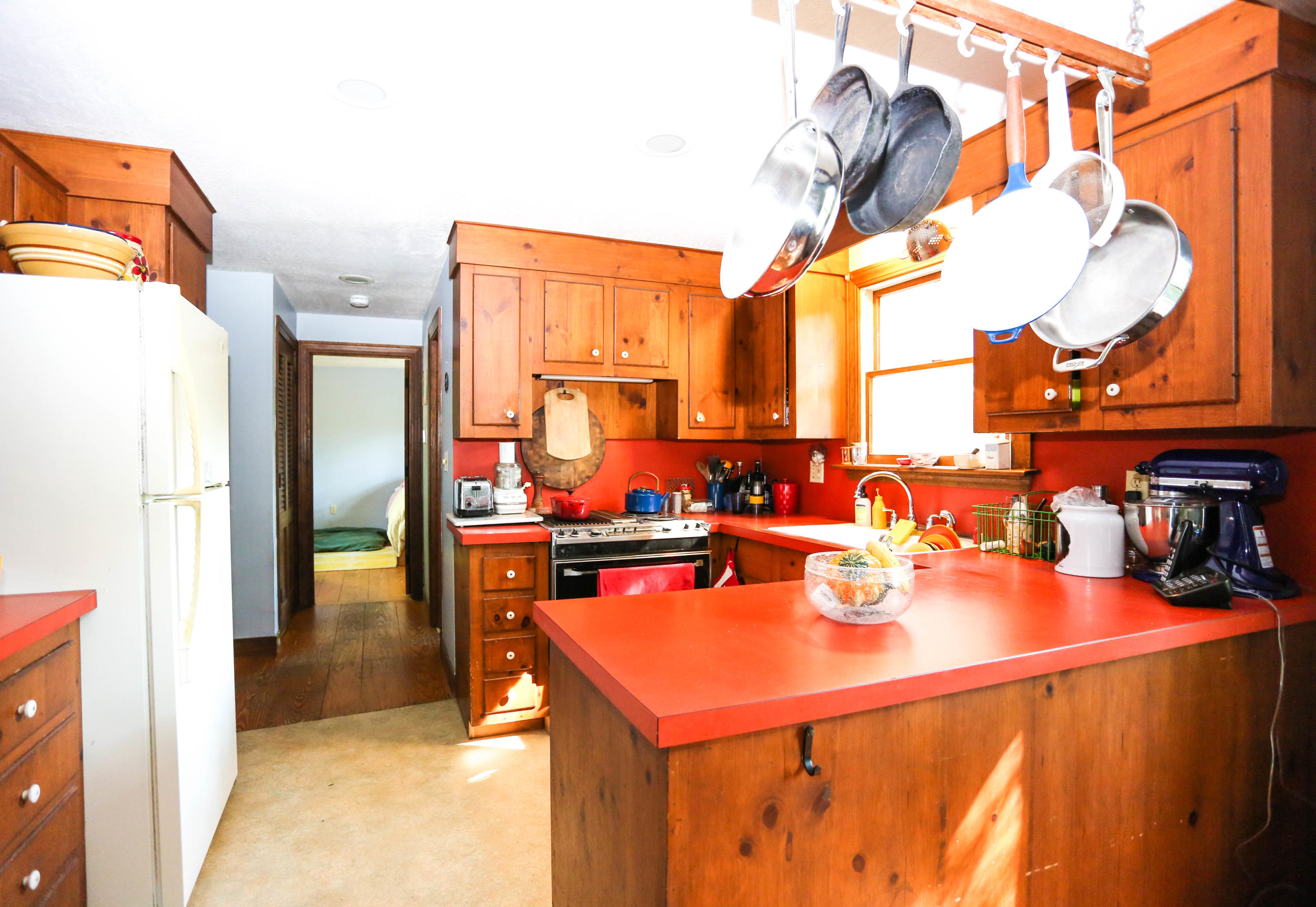 449 Poponessett Road Cotuit, MA 02635 - Photo 9 of 17 a kitchen with a sink a stove and a refrigerator
