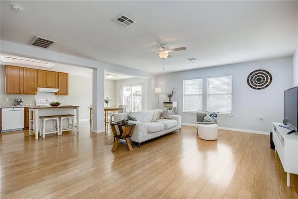 a view of kitchen island wooden floor and living room