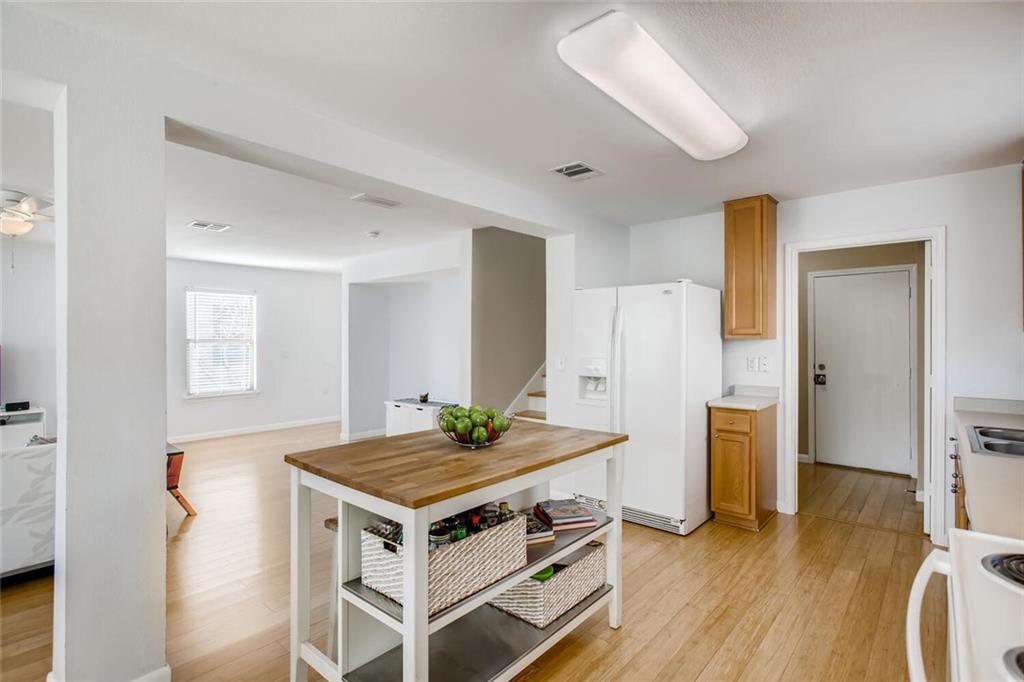 8813 Winter Haven Road Austin, TX 78747 - Photo 12 of 28 a view of kitchen island wooden floor and living room