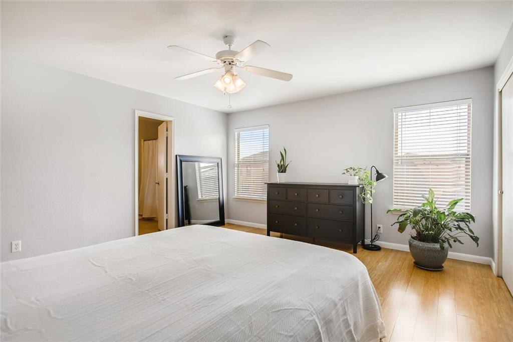 8813 Winter Haven Road Austin, TX 78747 - Photo 17 of 28 a bedroom with a bed and a chandelier