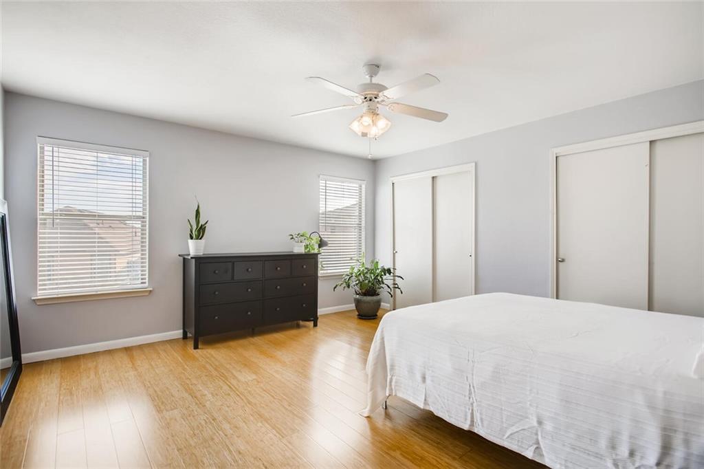 8813 Winter Haven Road Austin, TX 78747 - Photo 18 of 28 a bedroom with a bed and a chandelier