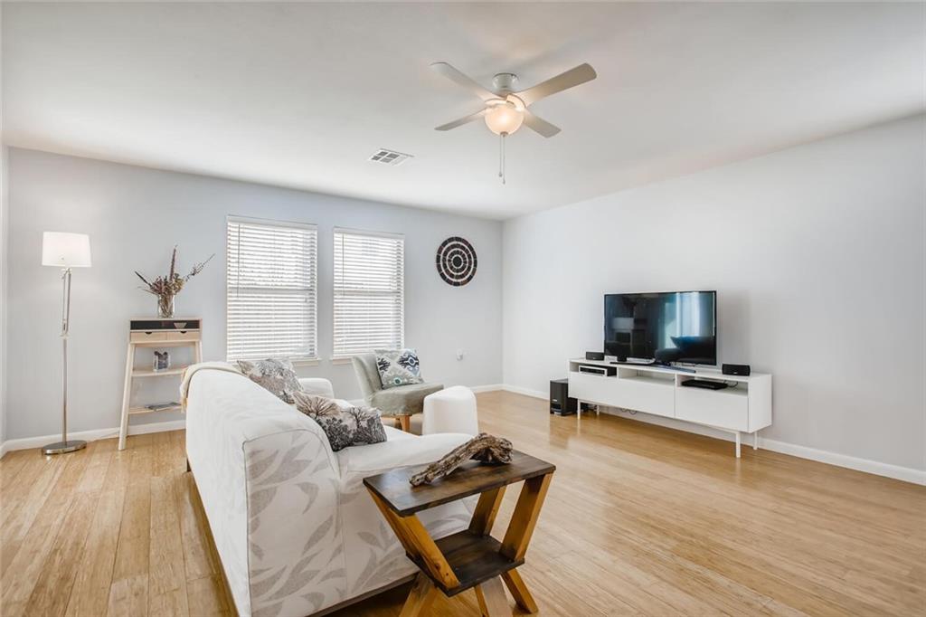 8813 Winter Haven Road Austin, TX 78747 - Photo 2 of 28 a living room with furniture and a flat screen tv