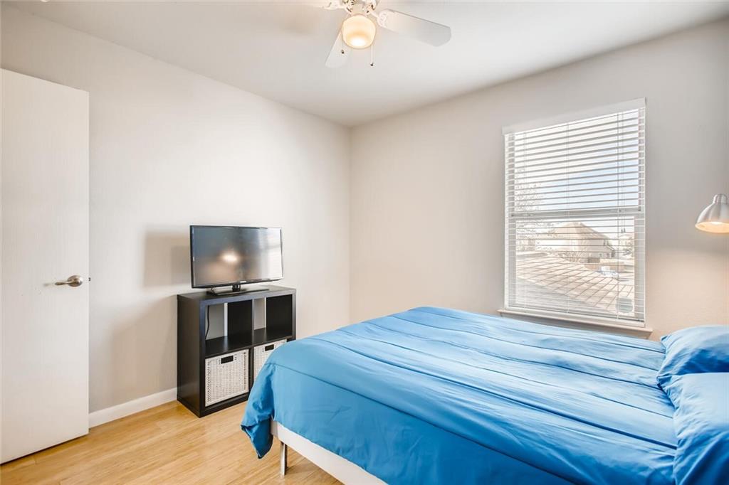 8813 Winter Haven Road Austin, TX 78747 - Photo 21 of 28 a bedroom with a bed and a flat screen tv