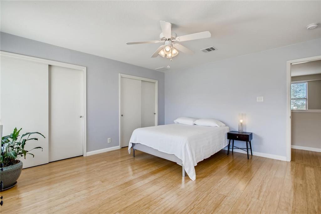 8813 Winter Haven Road Austin, TX 78747 - Photo 5 of 28 a bedroom with a bed and a potted plant