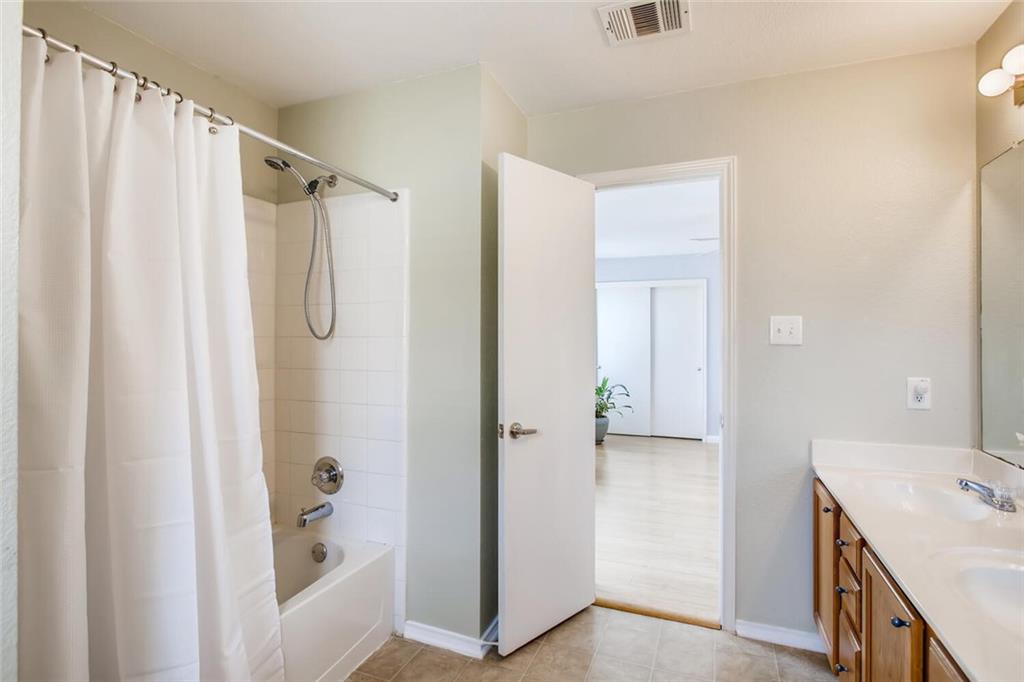 8813 Winter Haven Road Austin, TX 78747 - Photo 6 of 28 a bathroom with a shower and a sink