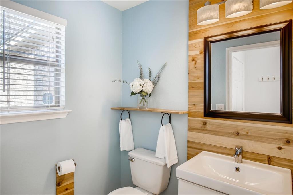 8813 Winter Haven Road Austin, TX 78747 - Photo 7 of 28 a bathroom with a toilet sink and mirror