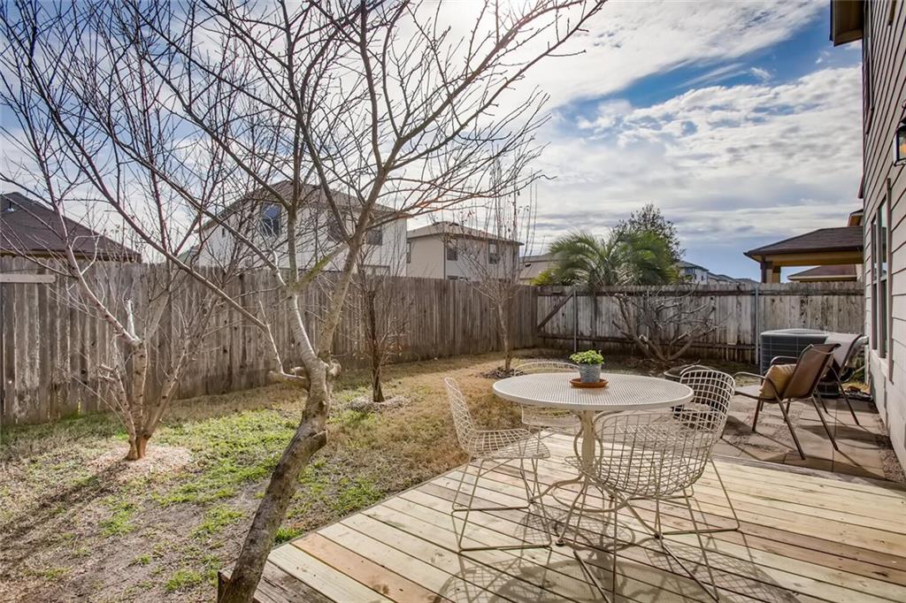 8813 Winter Haven Road Austin, TX 78747 - Photo 8 of 28 a backyard of a house with barbeque oven table and chairs