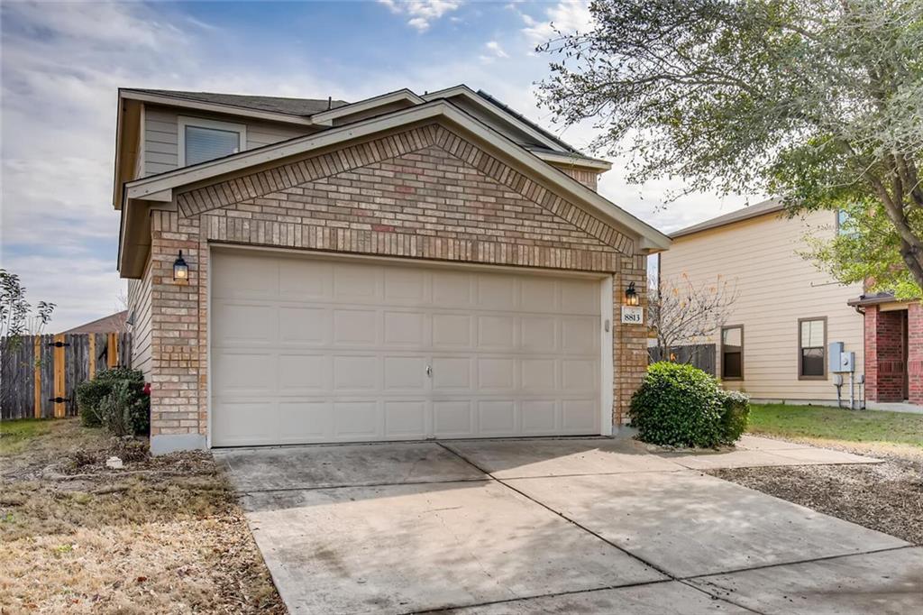 8813 Winter Haven Road Austin, TX 78747 - Photo 10 of 28 a front view of a house with a yard and garage