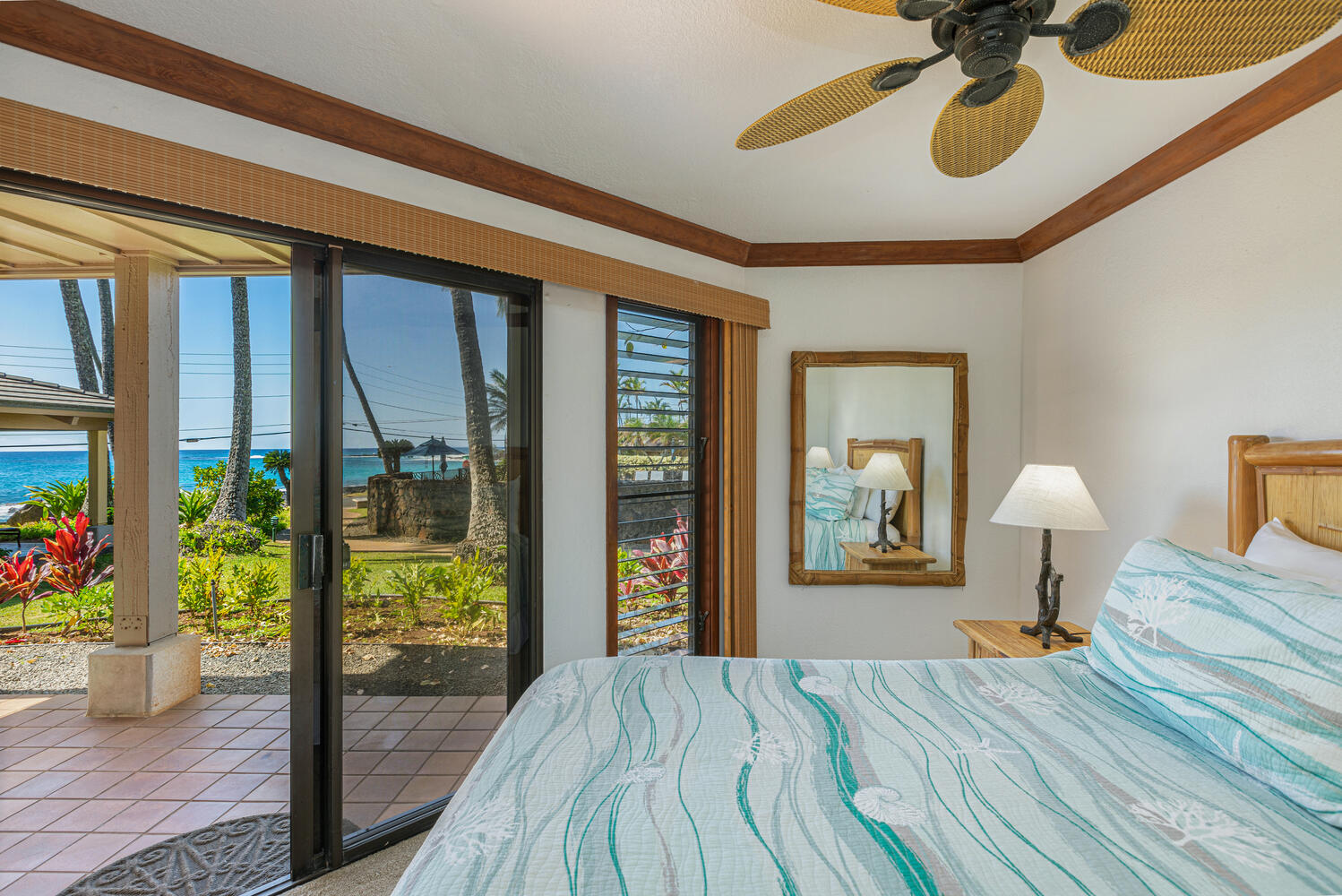 1870 Hoone Road, Unit 200 Koloa, HI 96756 - Photo 11 of 23 a bedroom with a bed and wooden floor