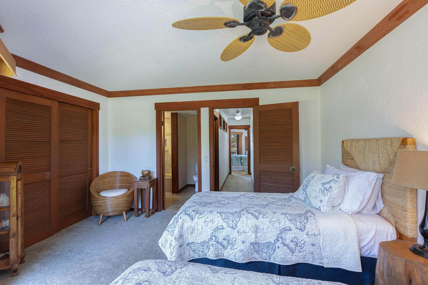 1870 Hoone Road, Unit 200 Koloa, HI 96756 - Photo 15 of 23 a bedroom with a large bed and a chandelier