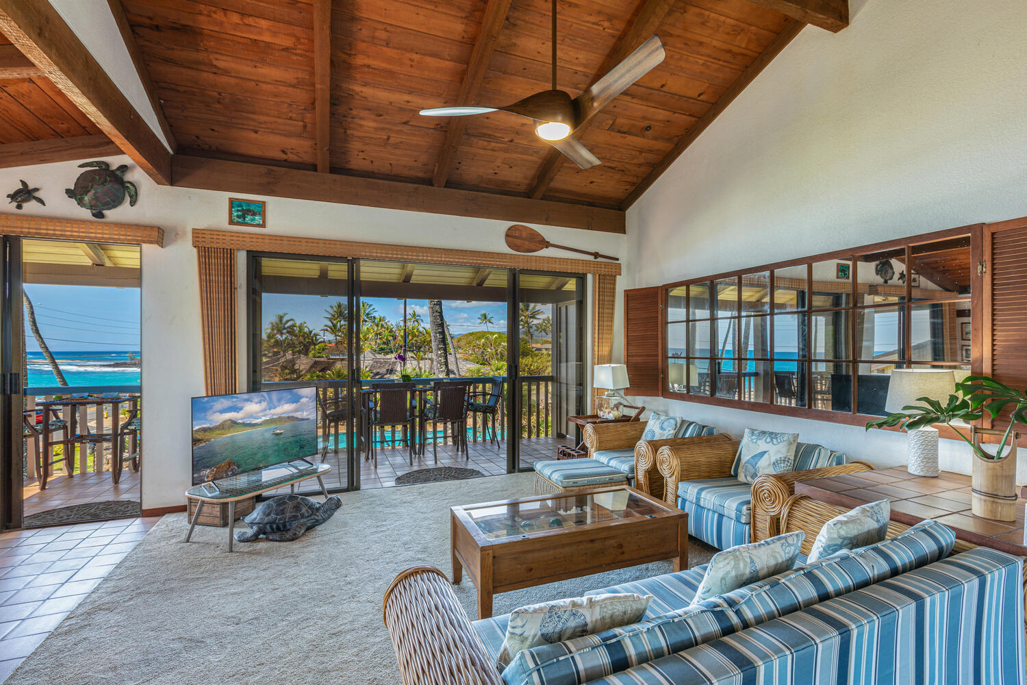 1870 Hoone Road, Unit 200 Koloa, HI 96756 - Photo 5 of 23 a living room with furniture and large windows