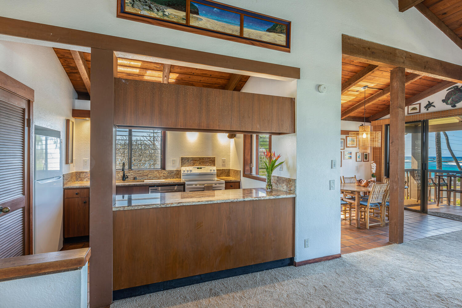 1870 Hoone Road, Unit 200 Koloa, HI 96756 - Photo 6 of 23 a kitchen with stainless steel appliances granite countertop a refrigerator and a stove
