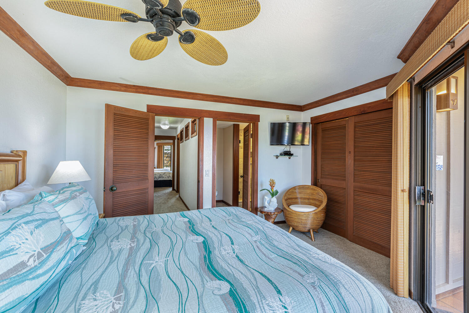 1870 Hoone Road, Unit 200 Koloa, HI 96756 - Photo 10 of 23 a bedroom with a bed and a chandelier