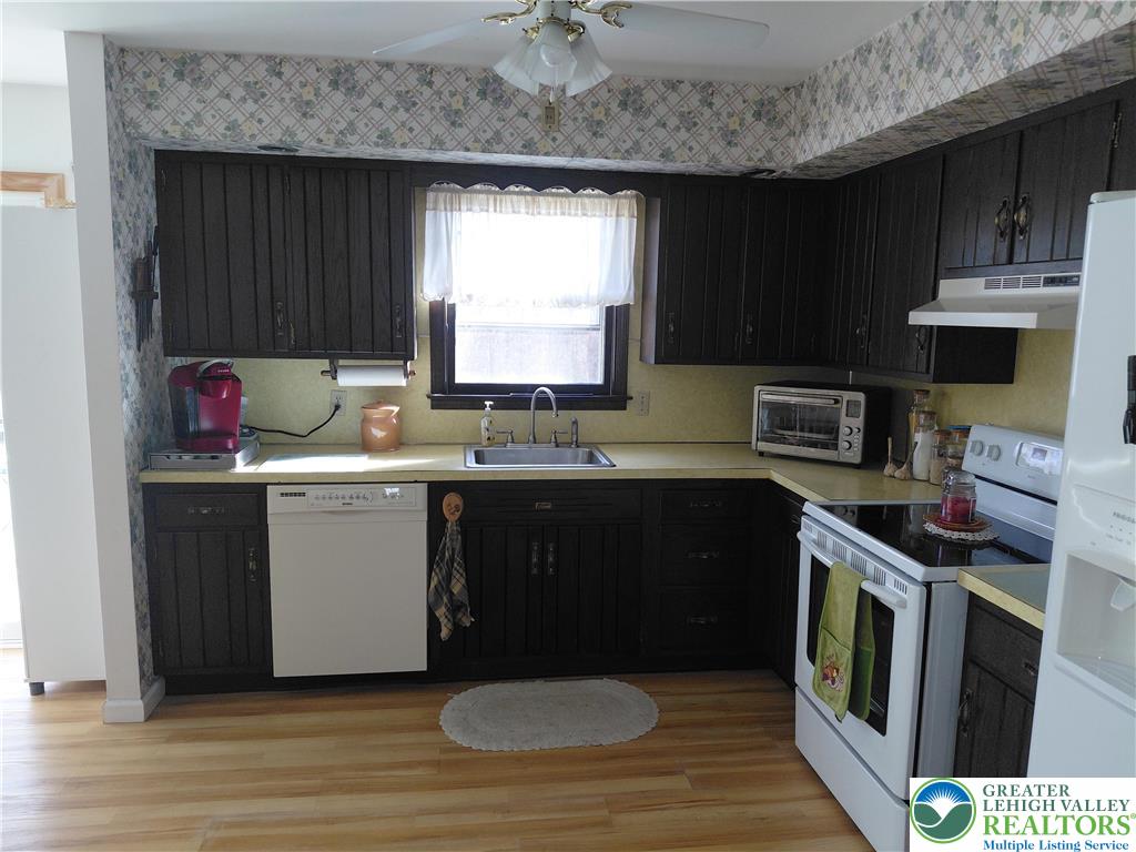 1020 East Main Street Weatherly, PA 18255 - Photo 24 of 35 a kitchen with a sink stove and cabinets