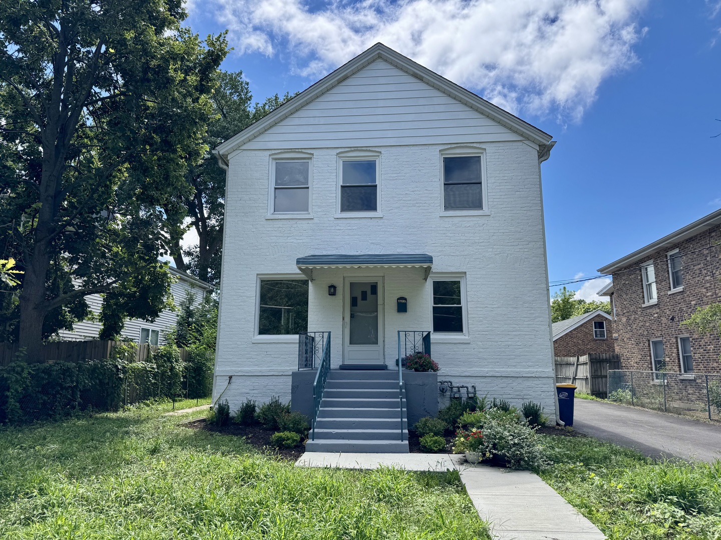 a front view of a house with a garden