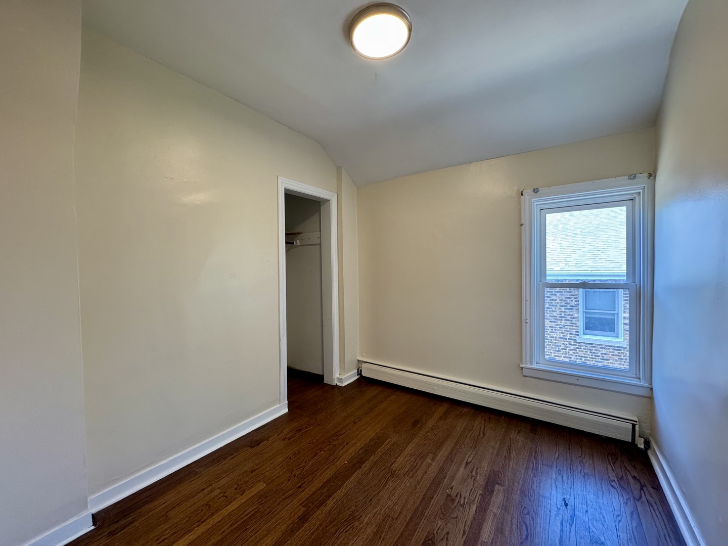844 Deerfield Road, Unit 2 Highland Park, IL 60035 - Photo 14 of 18 an empty room with wooden floor and windows